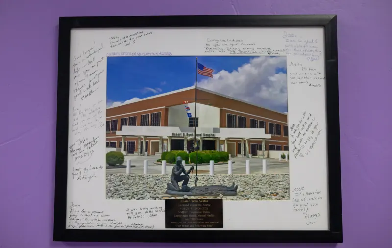 Framed photograph of a naval hospital surrounded by handwritten messages of thanks from colleagues