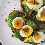 Avocado toast with eggs and salt and pepper. Your gut-brain axis could be affecting your mood.